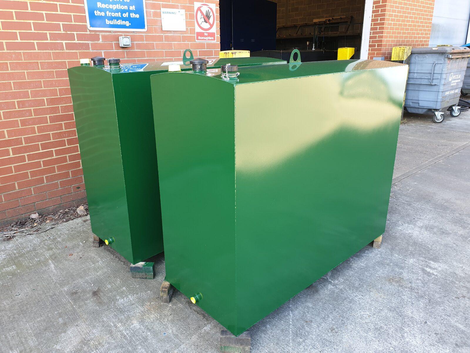 Two different sizes of green steel domestic heating oil tank